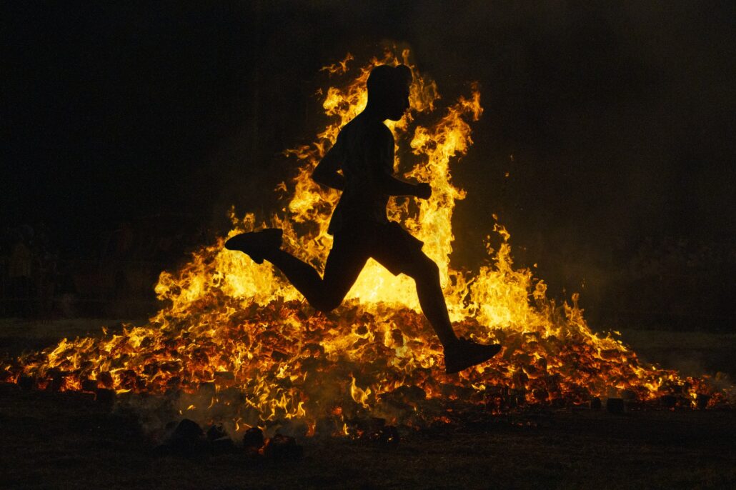 Summer solstice celebration jumping into the fire. Burning flames